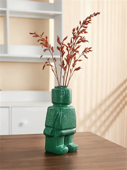 Vase Figura personnage vert moucheté avec des tiges séchées rouille